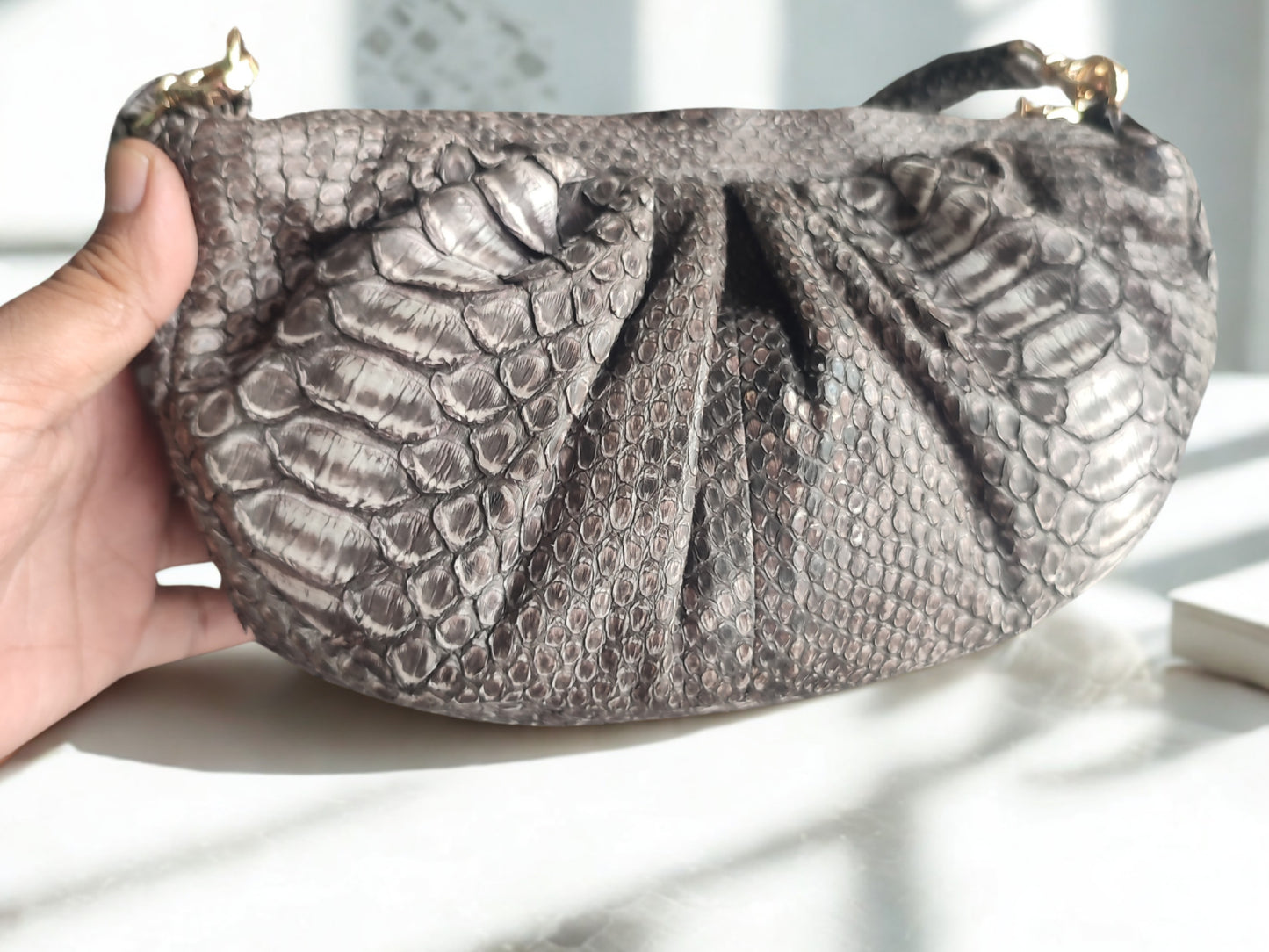 real snakeskin Croissant Small Leather Shoulder Bag on white table