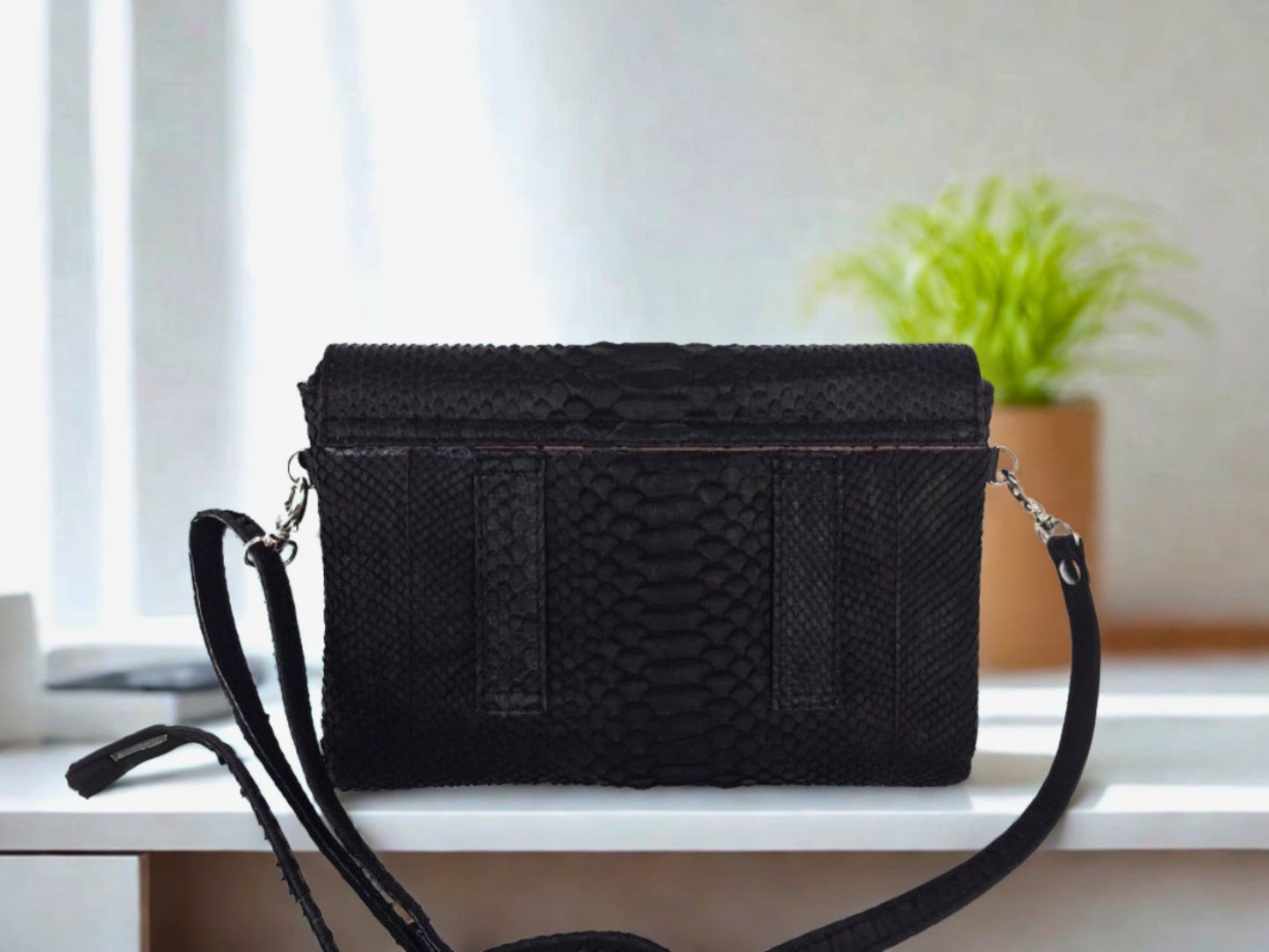 Snakeskin Leather Bag Back Waist Strap - black color back side view on table at office