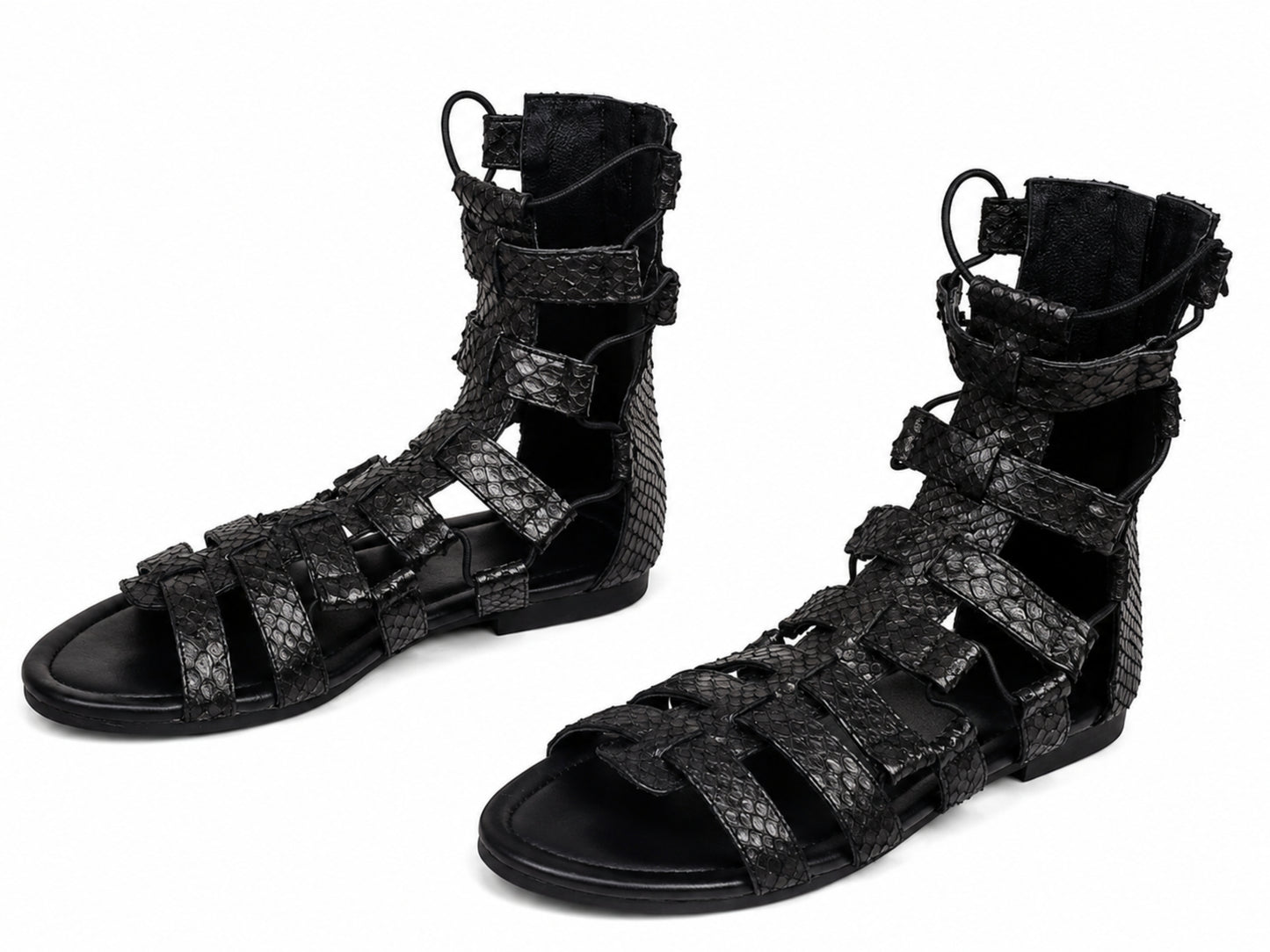 A pair of black strappy gladiator sandals with a textured python-patterned upper, shown on a plain white background.