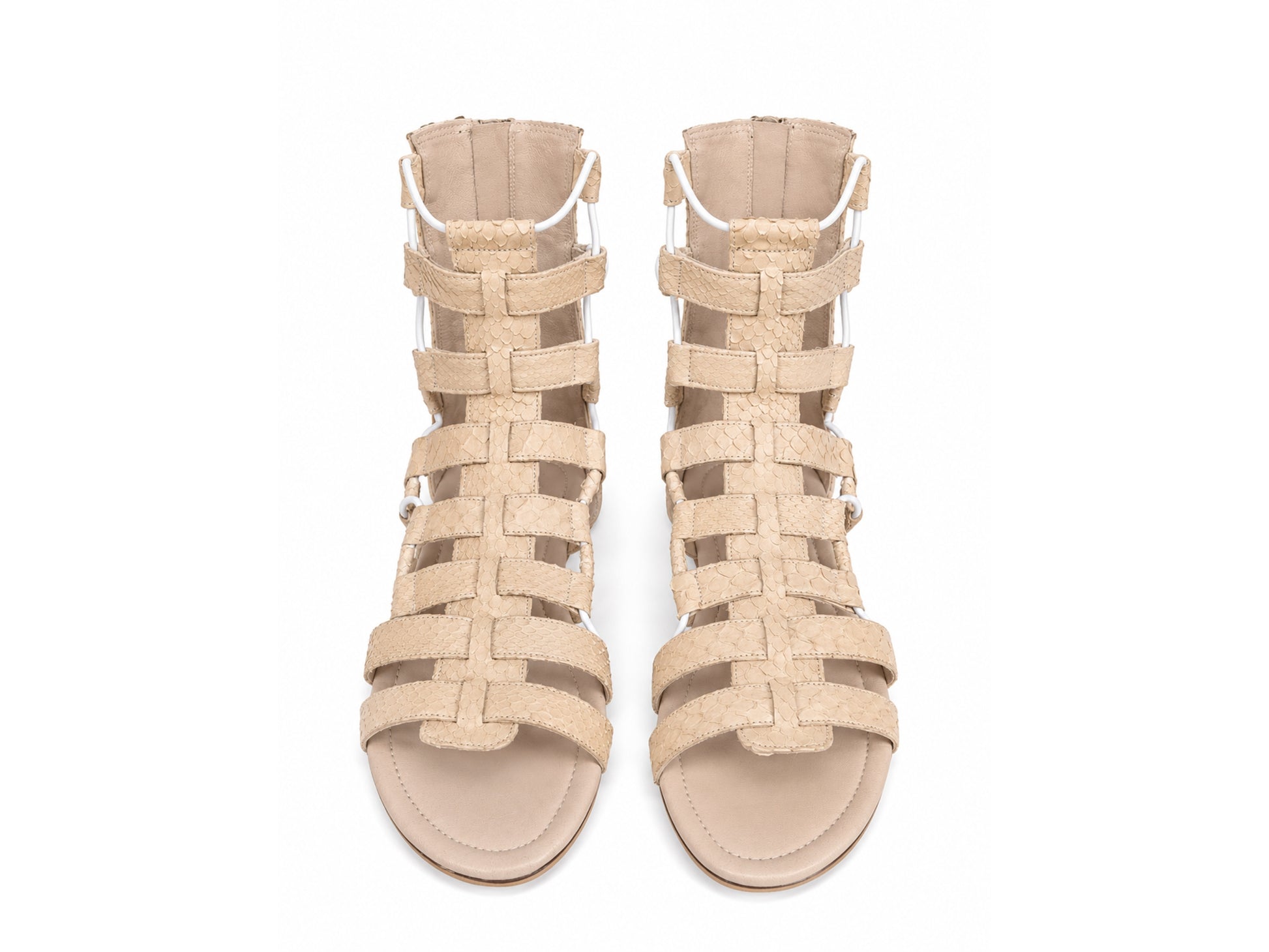 A pair of beige strappy high-heeled sandals with woven straps and side buckles, shown from a top-down view on a white background.