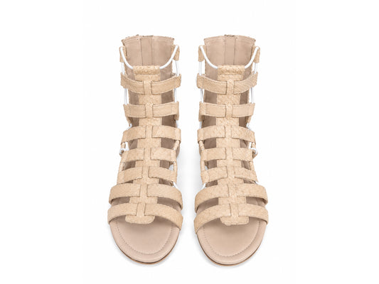 A pair of beige strappy high-heeled sandals with woven straps and side buckles, shown from a top-down view on a white background.