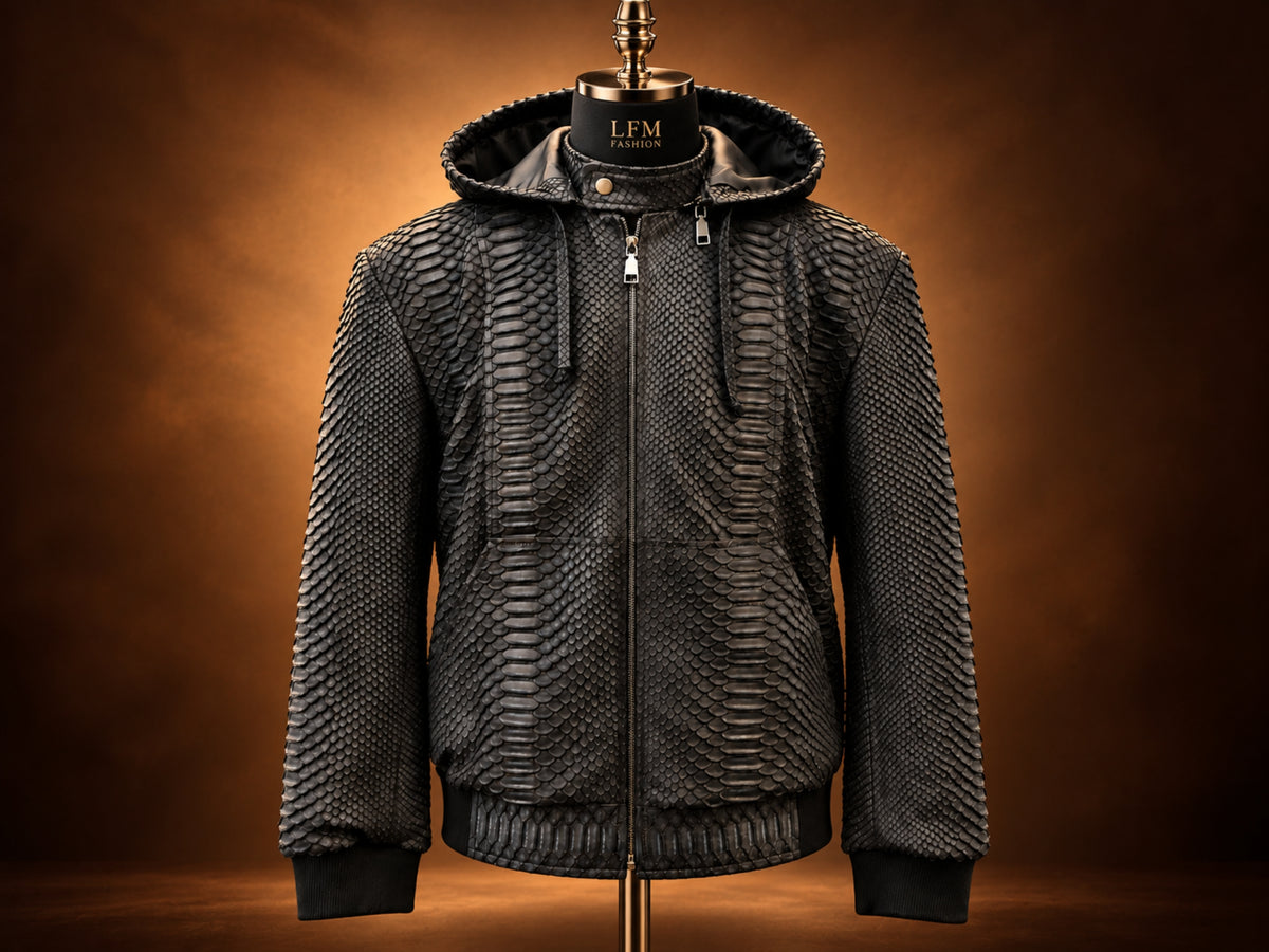A black textured hooded jacket displayed on a mannequin against a warm brown gradient background. The jacket features a unique scale-like pattern, a full front zipper, and ribbed cuffs and hem.