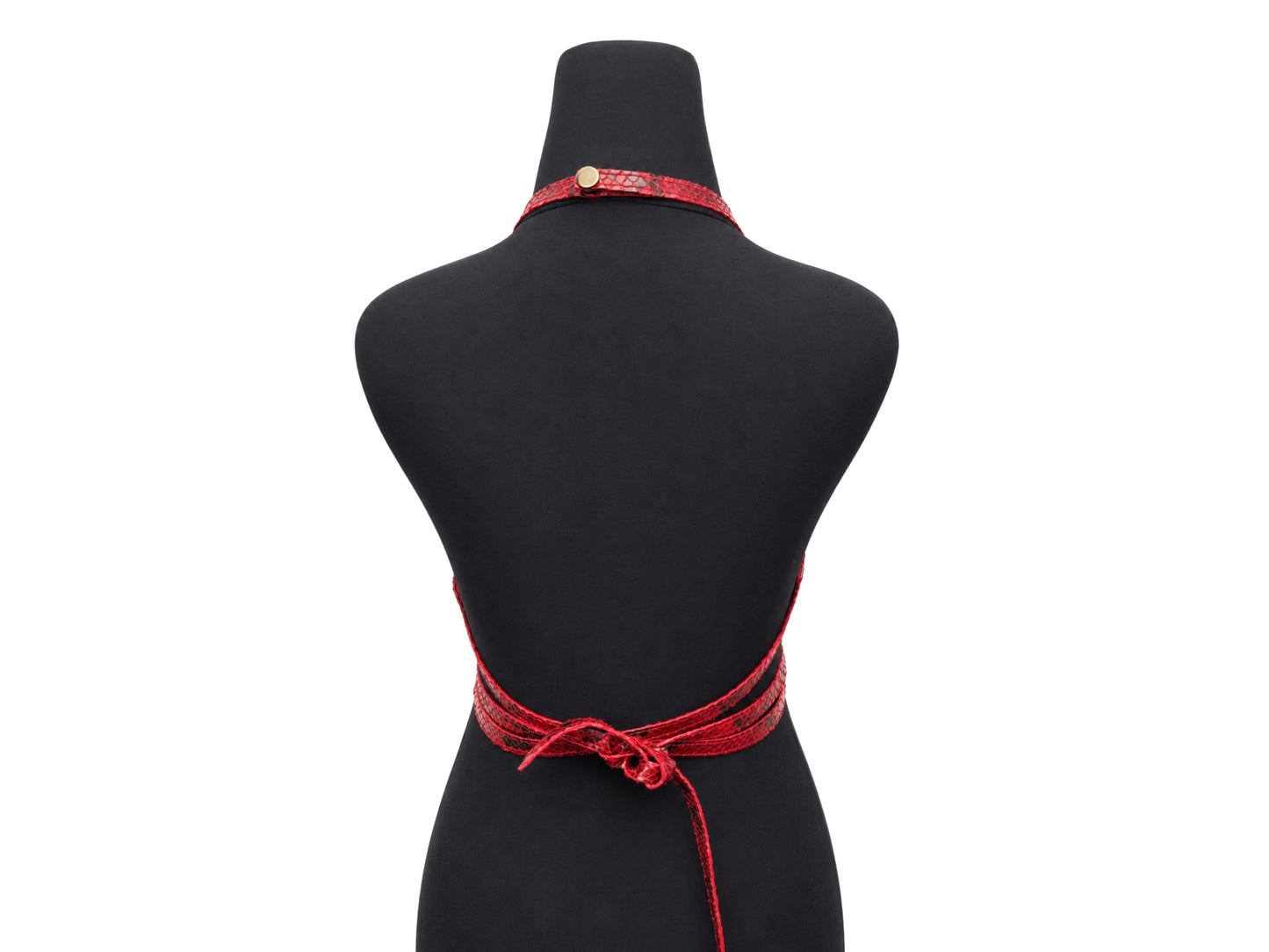 A red patterned halter-style necktie apron with a back waist tie, displayed on a black mannequin torso against a white background.