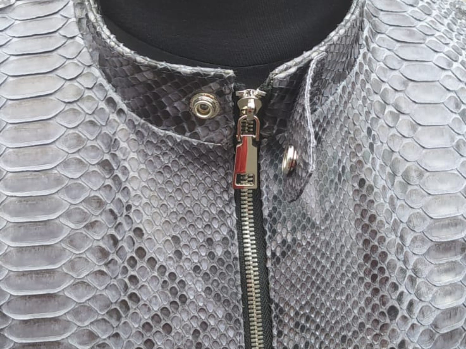 Close-up of a textured gray garment with a zipper