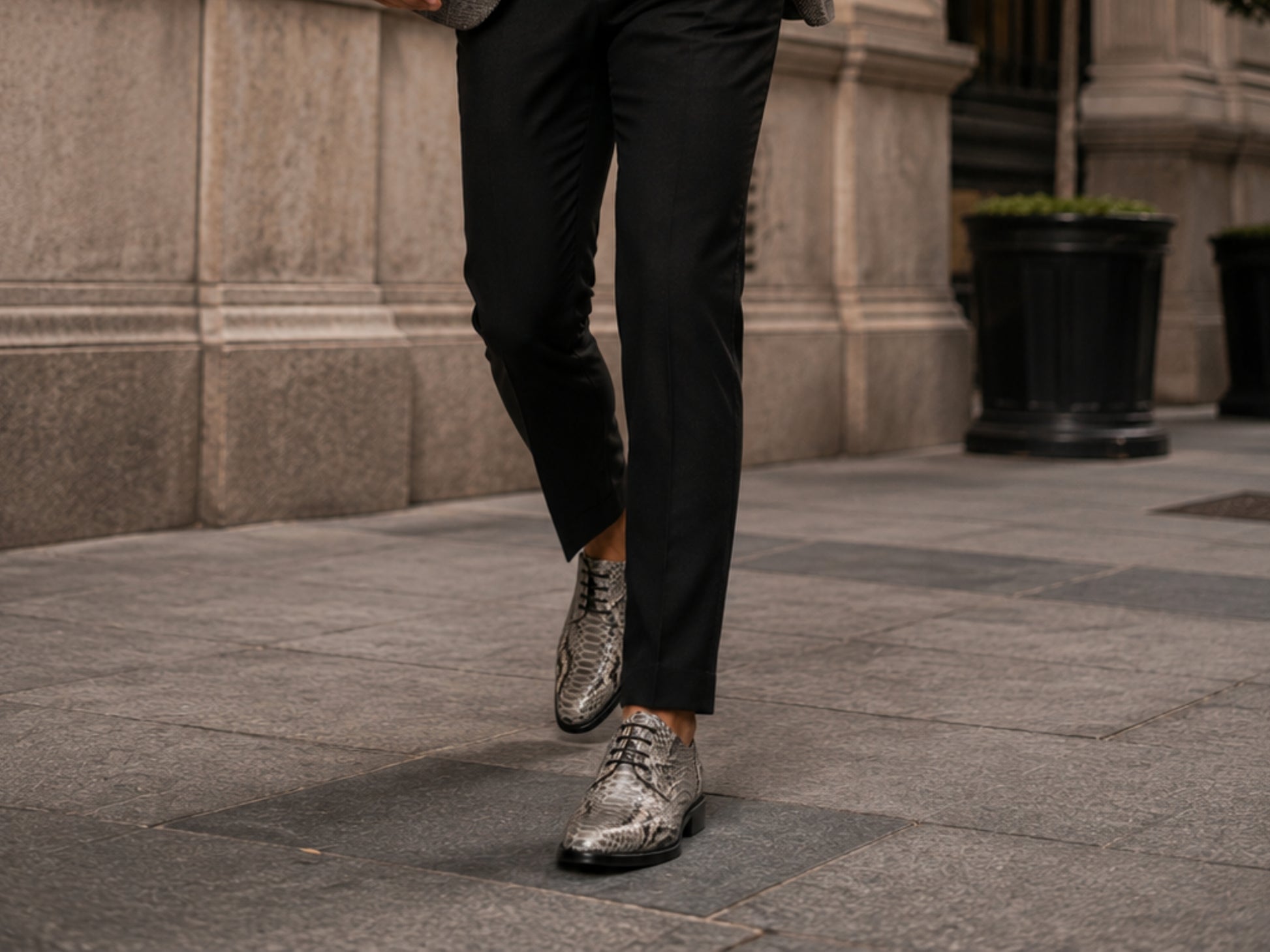 Man walking outdoors wearing natural gray python snakeskin dress shoes