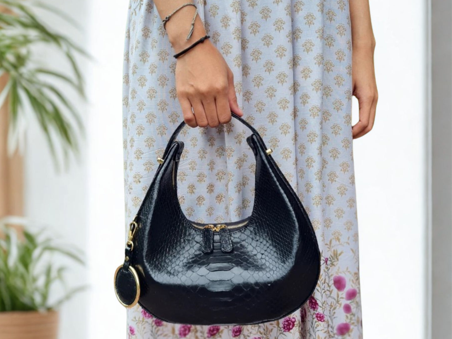 Half Moon Snakeskin Purse hold by a women model