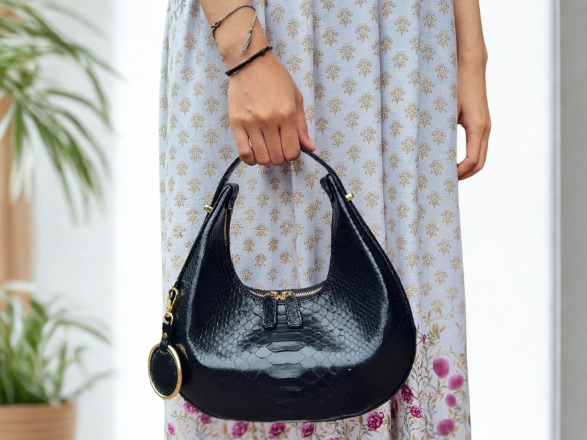 Half Moon Snakeskin Purse hold by a women model