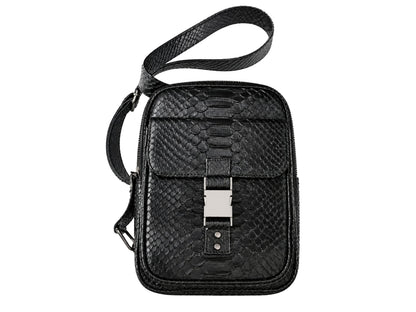 Black textured leather crossbody bag with a python-style pattern, featuring a front flap with a silver-tone metal buckle and a matching black shoulder strap, shown on a plain white background.