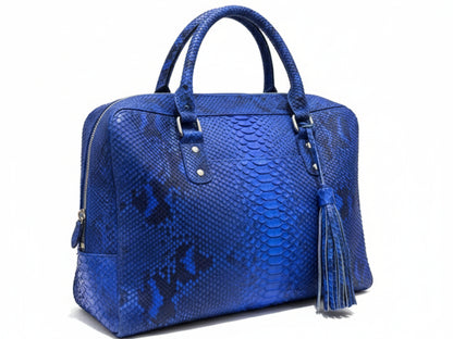 Blue textured handbag with a tassel on a white background