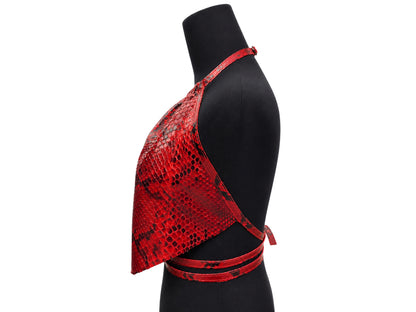A red and black snakeskin-patterned halter-style crop top displayed on a black mannequin torso against a plain white background.