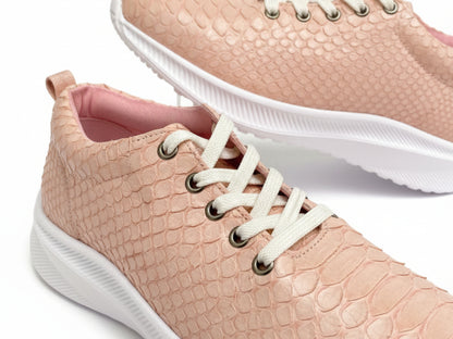 Pink textured sneakers with white laces and soles on a light background