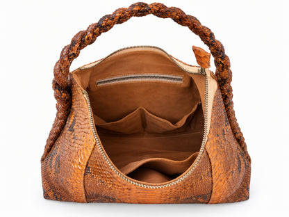 A brown snakeskin-textured handbag with a braided top handle, shown open to reveal a tan interior with multiple compartments and a zippered pocket.