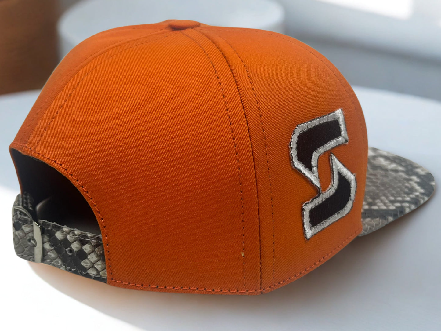 Syracuse embroidered snakeskin hat on side view