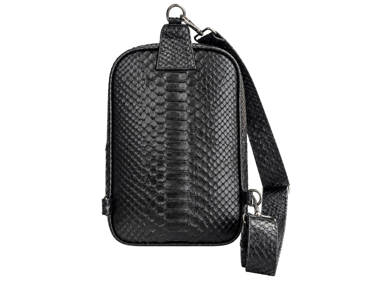 Black python-textured leather crossbody phone bag with a matching adjustable shoulder strap and silver-tone hardware, shown against a plain white background.