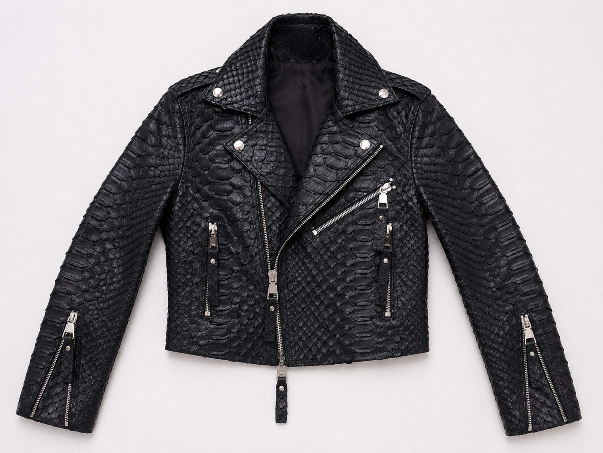 A black textured real snakeskin biker jacket with silver-tone hardware, displayed flat against a light gray background.