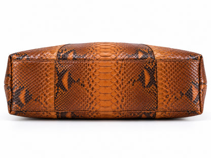A brown and black python-patterned leather handbag shown from the back, featuring textured scales and stitched paneling, on a white background.