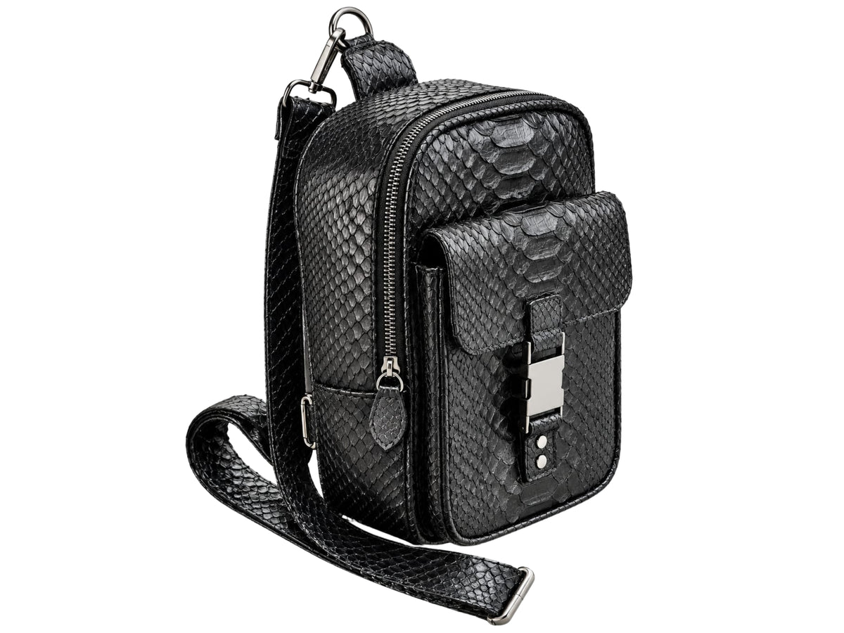 Black textured snakeskin crossbody bag with silver-tone hardware, shown on a plain white background.