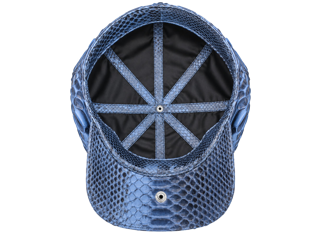 Navy Blue python-textured newsboy cap viewed from the back, showing the black fabric interior and ventilation eyelets on a white background.
