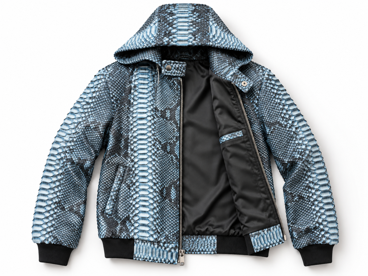 A hooded bomber jacket featuring a blue and gray python print pattern on the exterior, with a black satin-lined interior and black ribbed cuffs and hem.