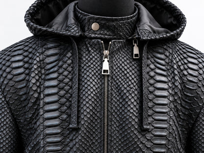 Black textured hooded jacket with a raised python-style scale pattern, front zipper, and drawstring hood, shown on a mannequin against a light gray background.
