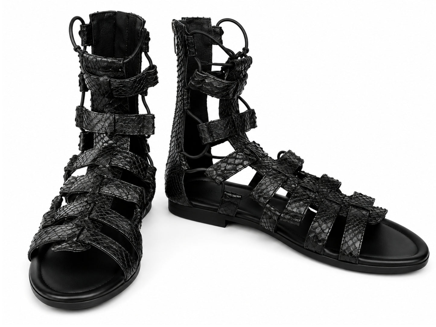 A pair of black strappy gladiator sandals with a textured python-skin pattern, shown on a plain white background.