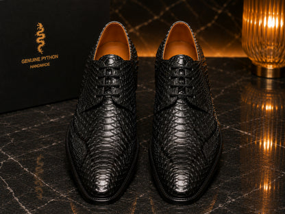 Pair of black genuine python snakeskin dress shoes with glossy natural scales