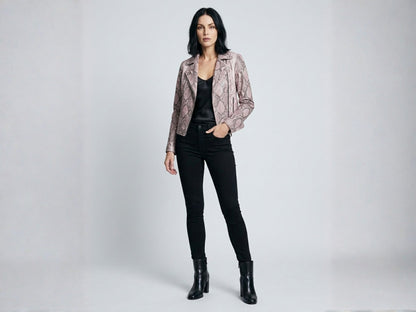 Full body studio portrait of model wearing pink python snakeskin moto jacket with black outfit