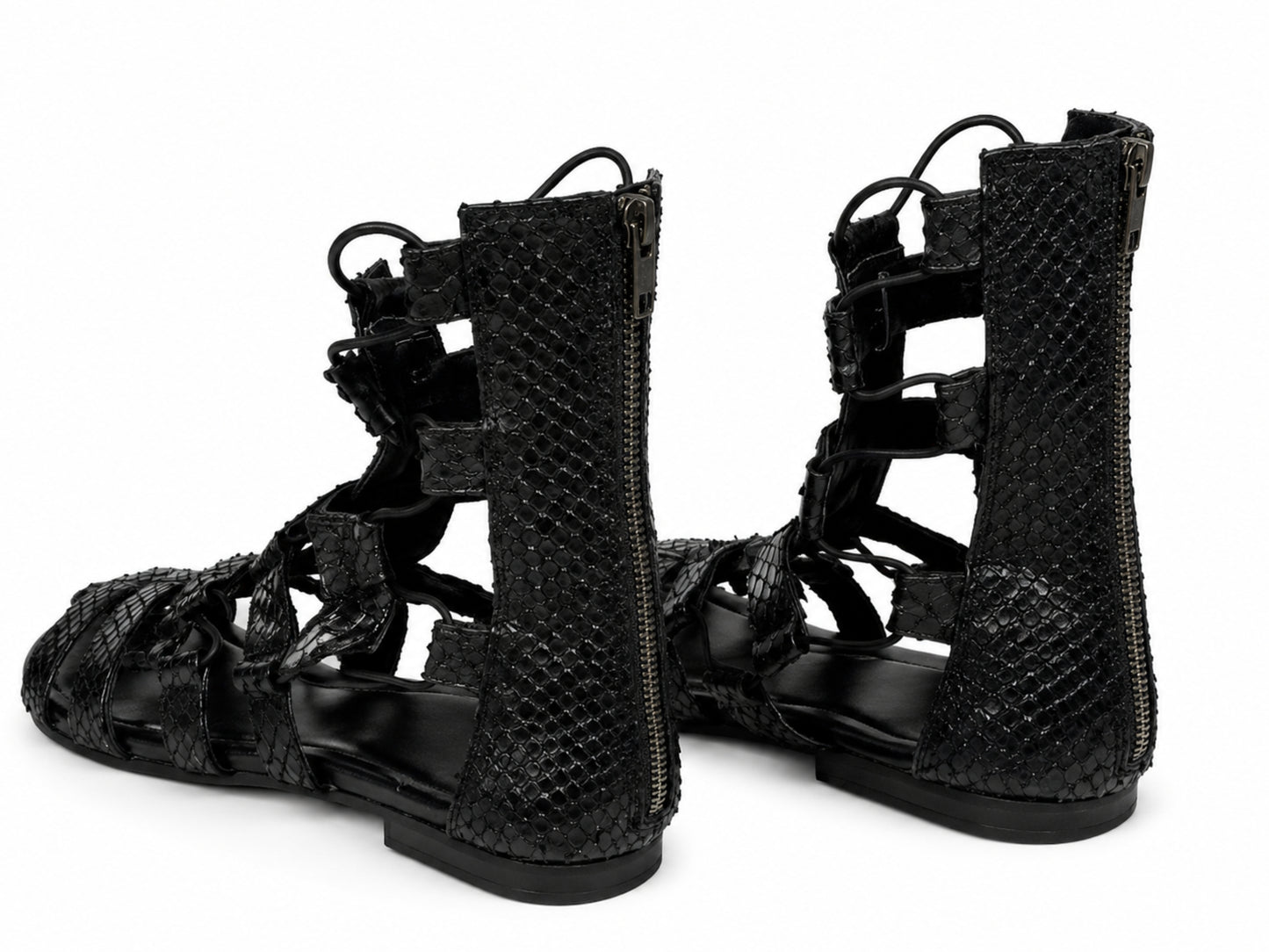 A pair of black snakeskin-textured lace-up sandals with side zippers, shown from a three-quarters angle on a white background.