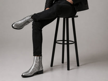 Man wearing silver gray genuine python snakeskin boots with black jeans in a fashion setting